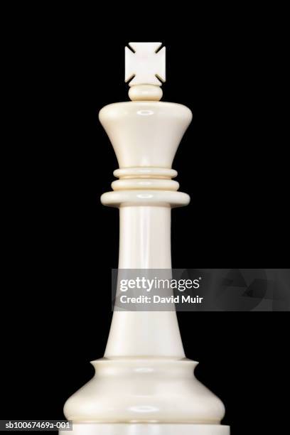 king chess piece on black background, close-up - king chess piece stock-fotos und bilder