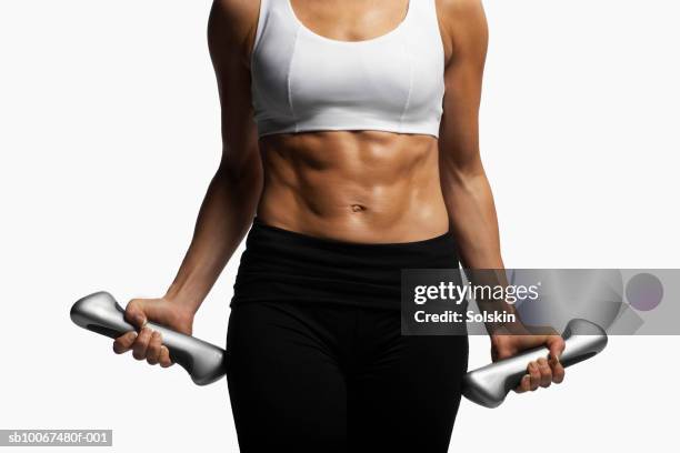 woman doing dumbbell curls with weights - bauchmuskel stock-fotos und bilder