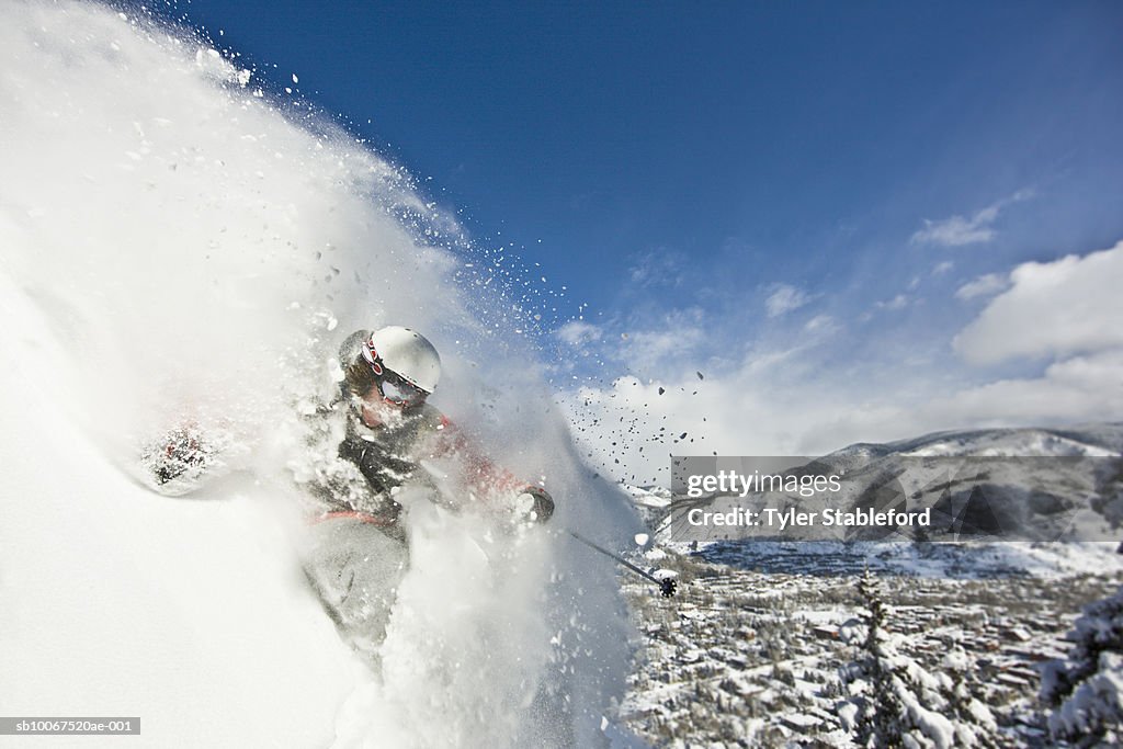 Skier making steep powder turn