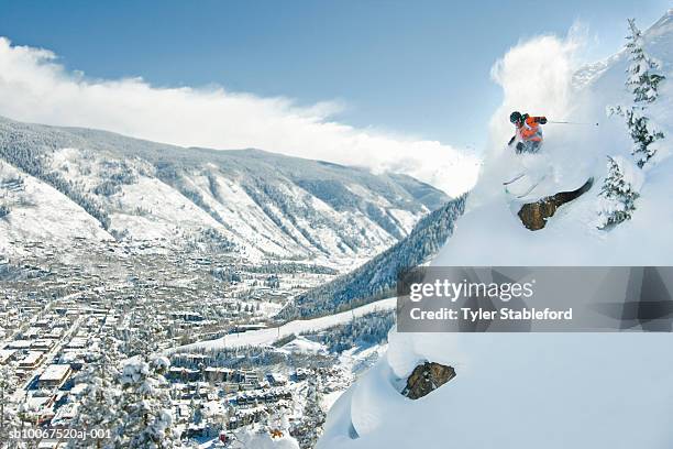 male skier making steep powder turn - aspen stock-fotos und bilder