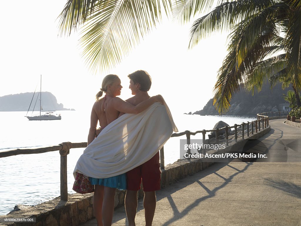 Mature couple walking on sidewalk