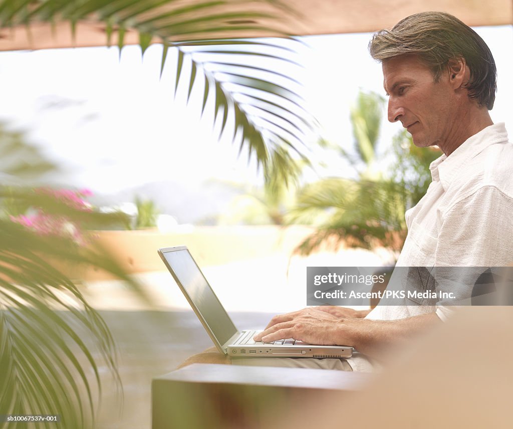 Mature man using laptop