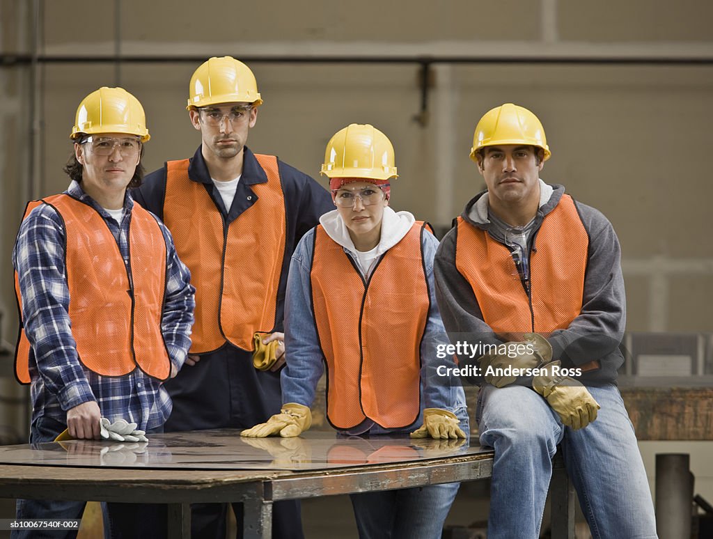 Construction workers wearing hard hat and safety vest, portrait