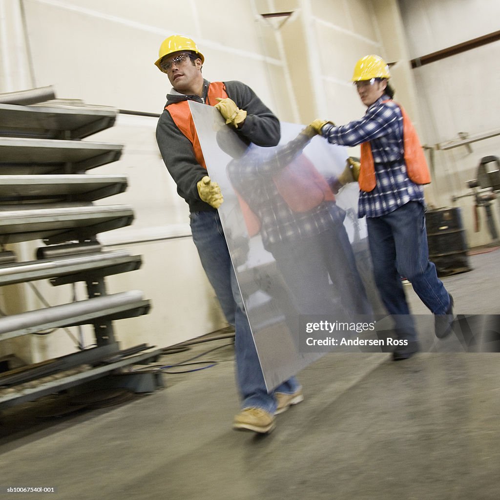 Men carrying steel metal