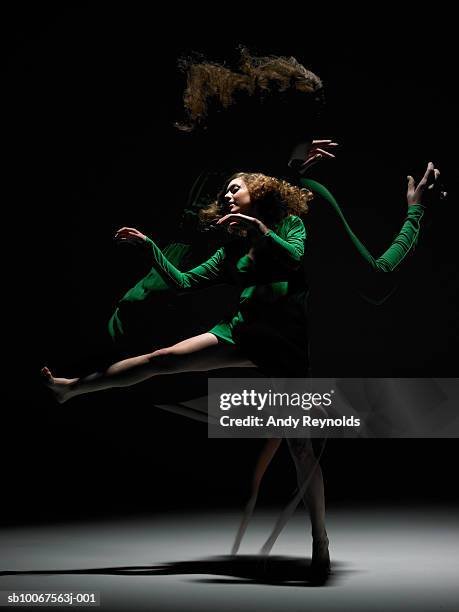 woman wearing green dress, dancing, (digital composite) - digitaal samengesteld beeld stockfoto's en -beelden