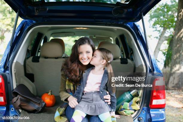 mother and daughter (6-7) sitting in car trunk - soccer mom stock pictures, royalty-free photos & images