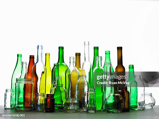 collection of bottles of various colours - bottiglia vetro foto e immagini stock