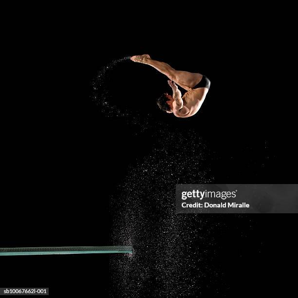 diver in mid-air - diving into water stock pictures, royalty-free photos & images