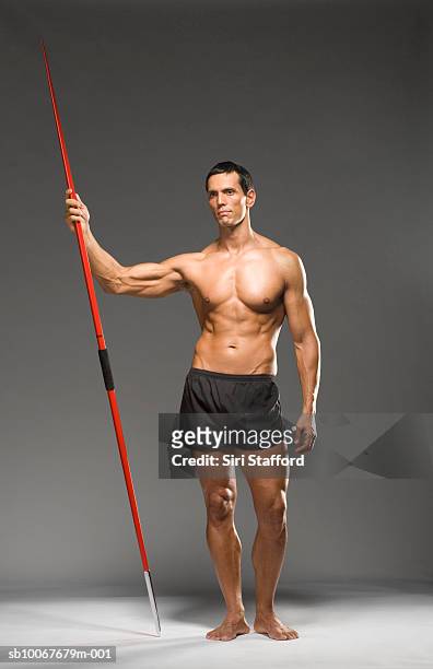 male athlete holding javelin, studio shot - barefoot stock pictures, royalty-free photos & images