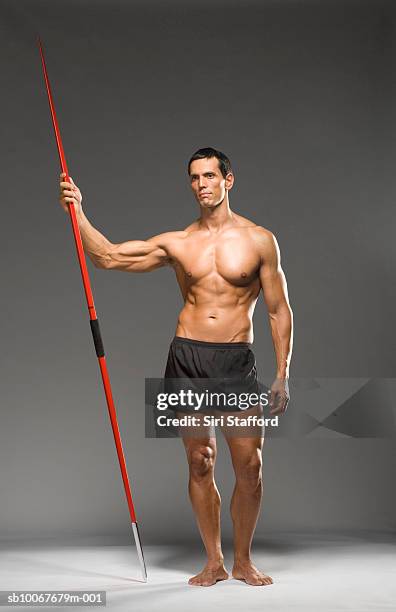 male athlete holding javelin, studio shot - barefoot men 個照片及圖片檔