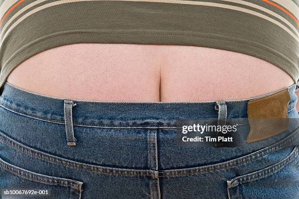 overweight man wearing jeans, mid section - gluteos fotografías e imágenes de stock