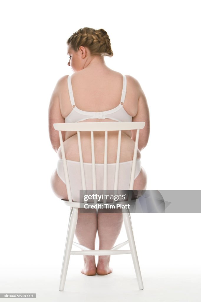 Overweight woman wearing bikini, rear view