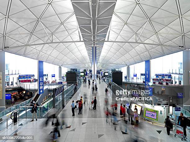 people in hong kong international airport - hong kong international airport stock pictures, royalty-free photos & images