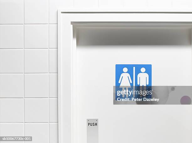 female and male sign on toilet door, close-up - public restroom stock-fotos und bilder