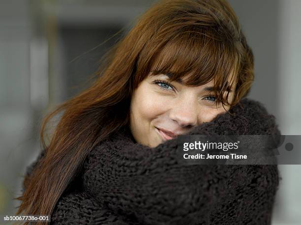 young woman wearing warm clothing, smiling, portrait - tossing hair facing camera woman outdoors stock pictures, royalty-free photos & images