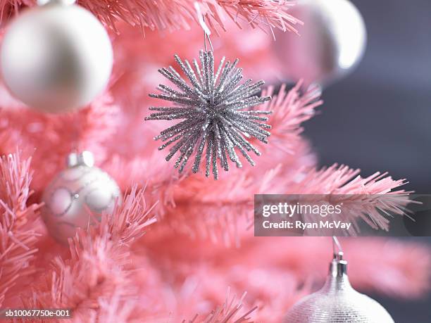 christmas ornaments on pink christmas tree, close-up - kitsch stock pictures, royalty-free photos & images