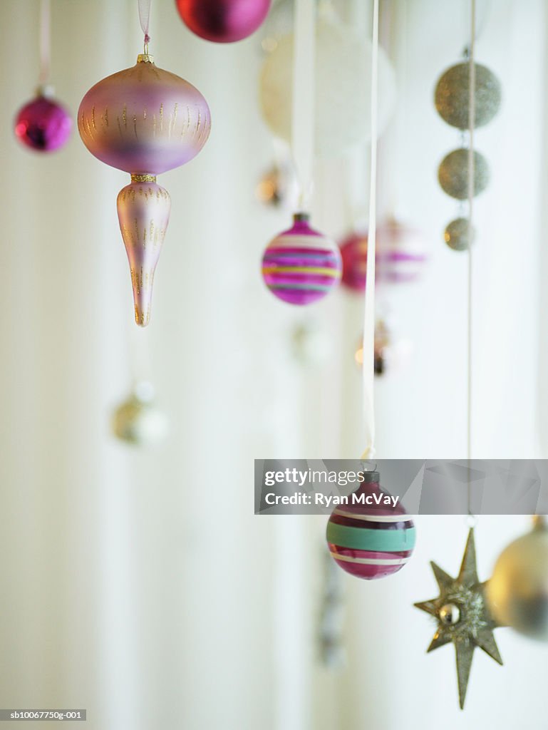 Christmas ornaments hanging from strings