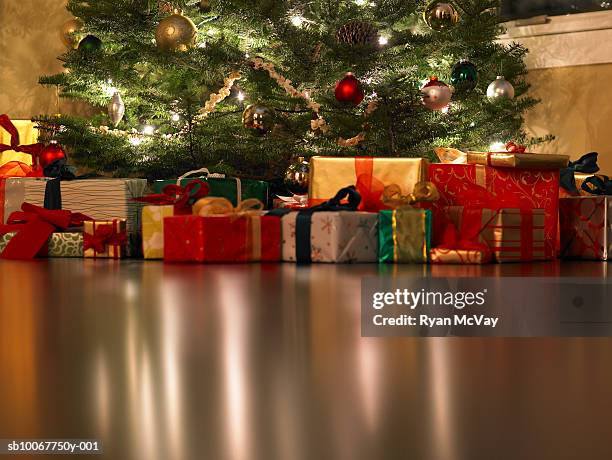 presents under christmas tree, surface level - christmas tree presents stock-fotos und bilder