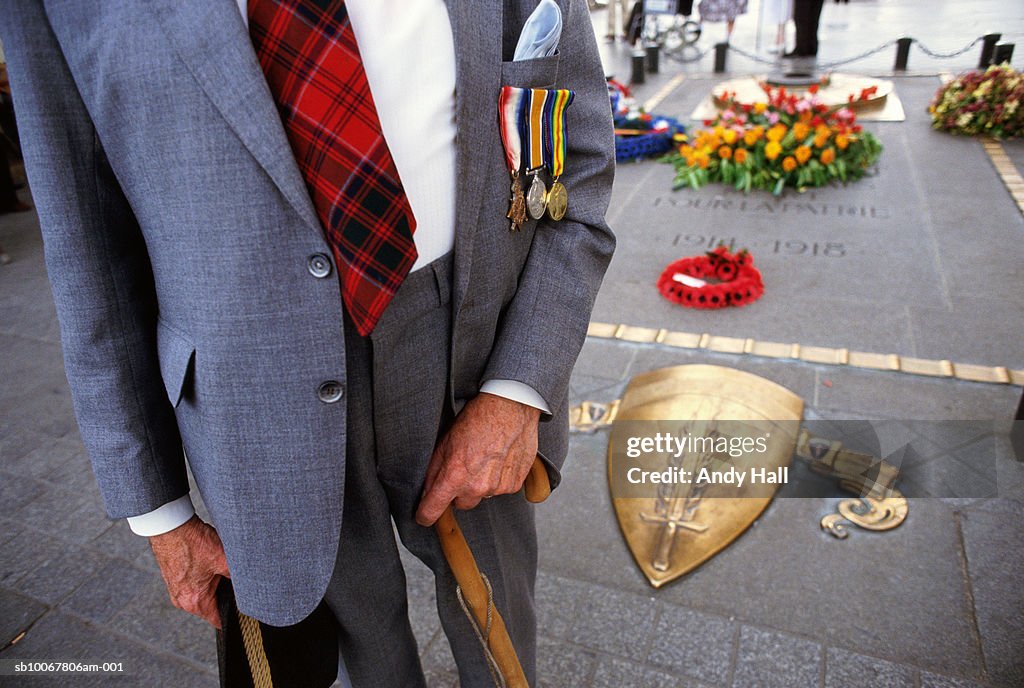 France, Somme, mid section of veteran in front of World War I memorial