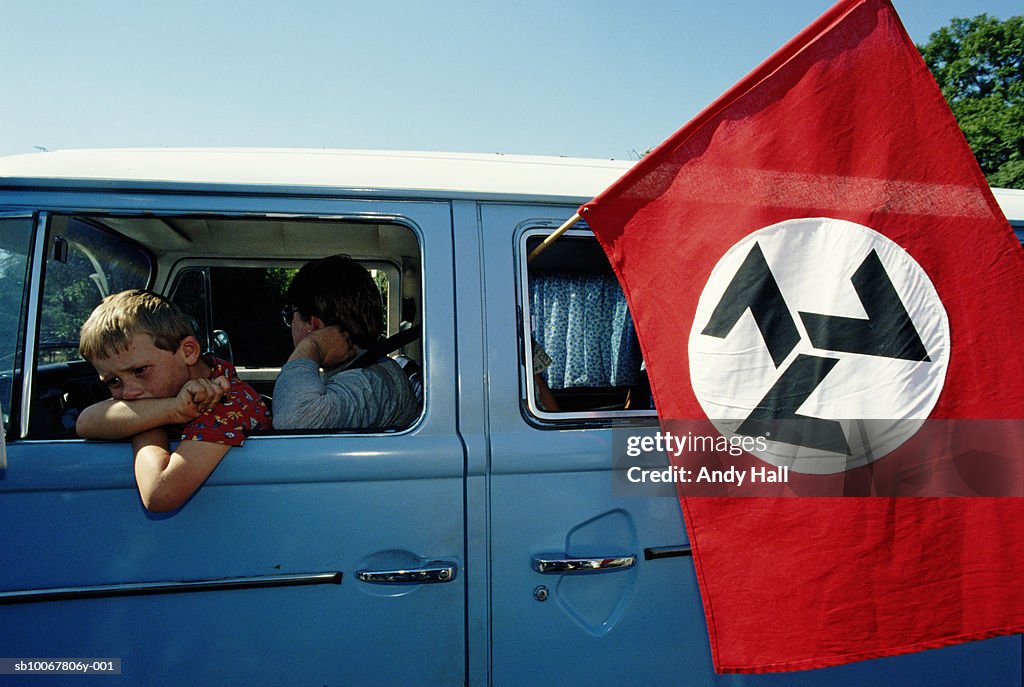 South Africa, Rustenburg, mother and son 910-11) in van with AWB flag