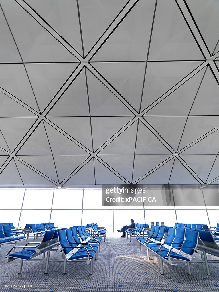 Person in waiting room at Hong Kong International Airport