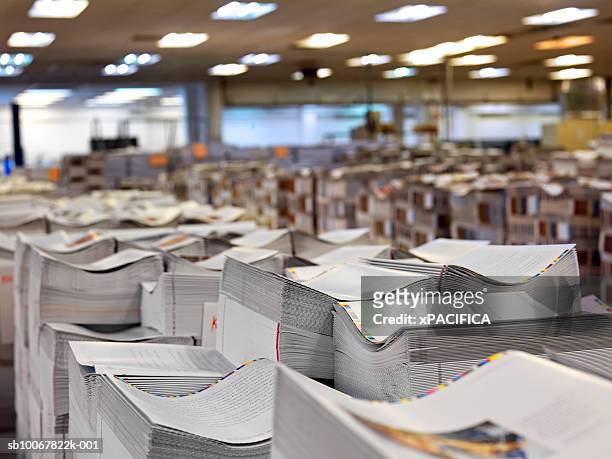 stacks of printed paper at printing press - paper industry stock pictures, royalty-free photos & images