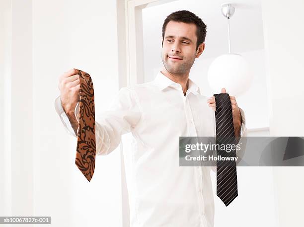 man holding two ties - holding two things stock pictures, royalty-free photos & images