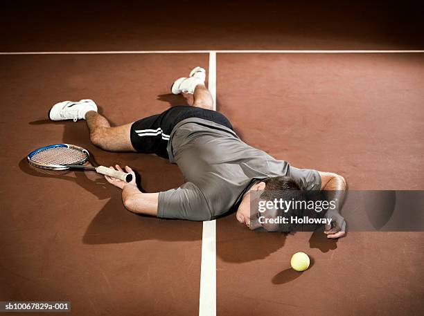 tennis player lying unconscious on court - defeat funny stock pictures, royalty-free photos & images