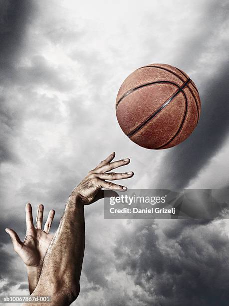 man throwing basketball in air, close-up of hands - basketball close up ストックフォトと画像