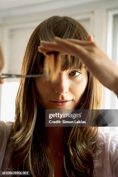 woman cutting hair with scissors, close-up - bangs bildbanksfoton och bilder