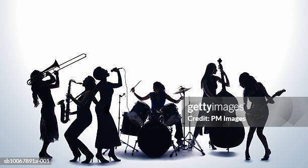 silhouette of female musicians - drum percussion instrument stock-fotos und bilder