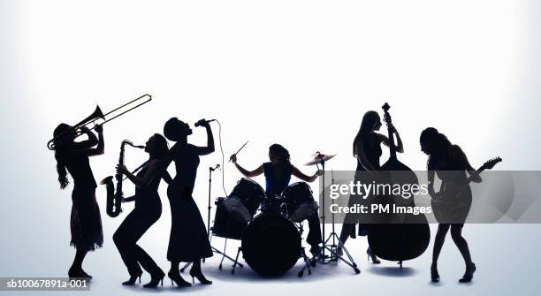 silhouette of female musicians - instrumento de sopro imagens e fotografias de stock