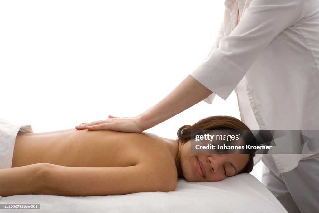 Woman receiving massage, smiling