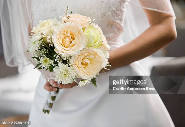 bride holding bouquet, mid section - matrimonio foto e immagini stock