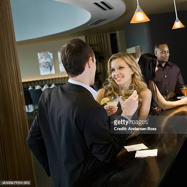 young man and woman flirting at bar counter - 30 34 years stock pictures, royalty-free photos & images