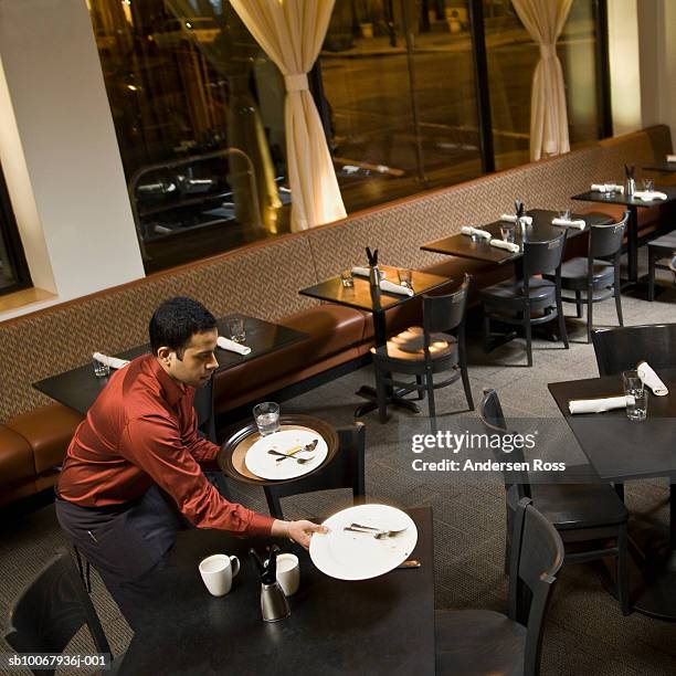 waiter cleaning table in restaurant, elevated view - cleaning after party stock pictures, royalty-free photos & images