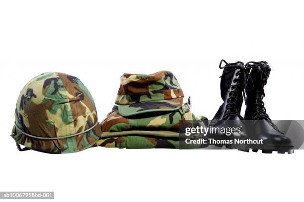 military helmet, hat, shirt and boots - military uniform folded stock pictures, royalty-free photos & images