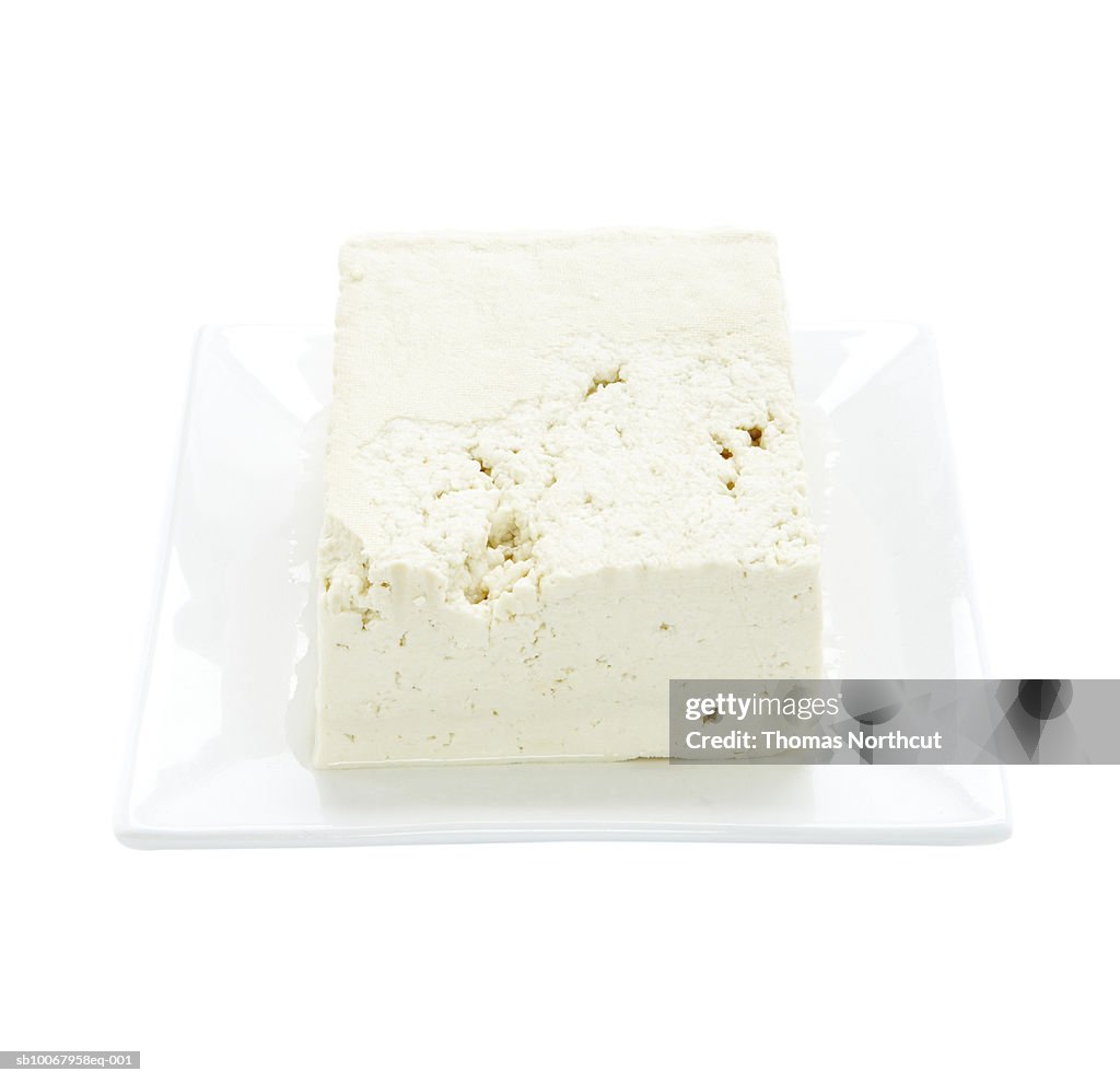 Tofu on plate on white background