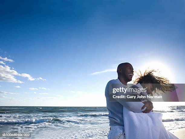 father and daughter (6-7) playing at beach, smiling - beach florida family stockfoto's en -beelden