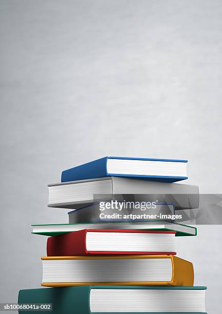 stack of books on grey background - pile of books stock-fotos und bilder