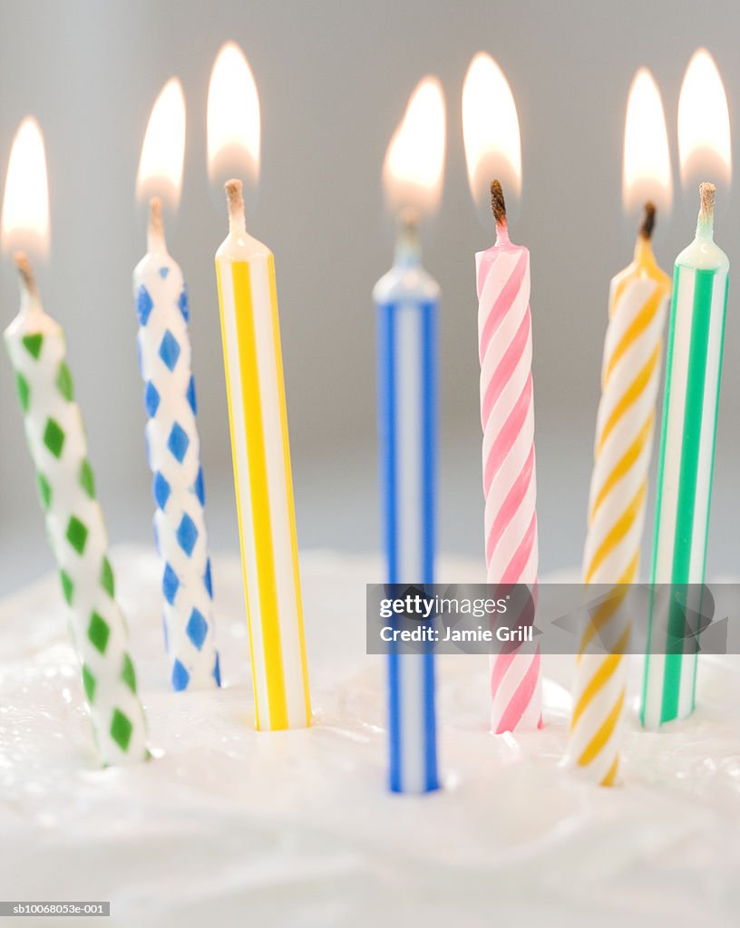 Colorful candles on cake, close-up