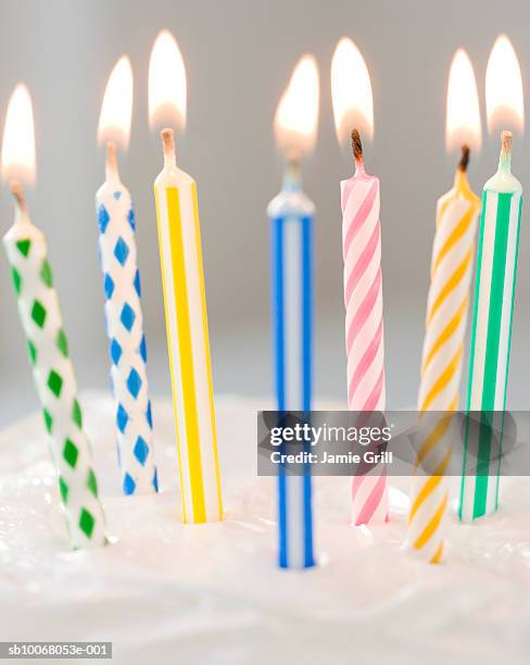 colorful candles on cake, close-up - candeline di compleanno foto e immagini stock