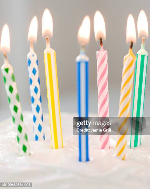 colorful candles on cake, close-up - birthday candles stock pictures, royalty-free photos & images