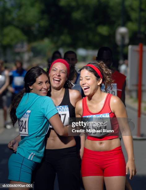 three female marathon runners laughing - women marathon stock pictures, royalty-free photos & images
