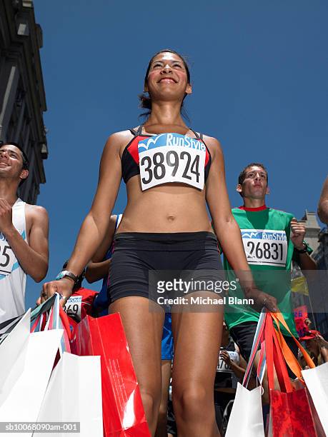 woman in marathon holding shopping bags - sales effort stock pictures, royalty-free photos & images