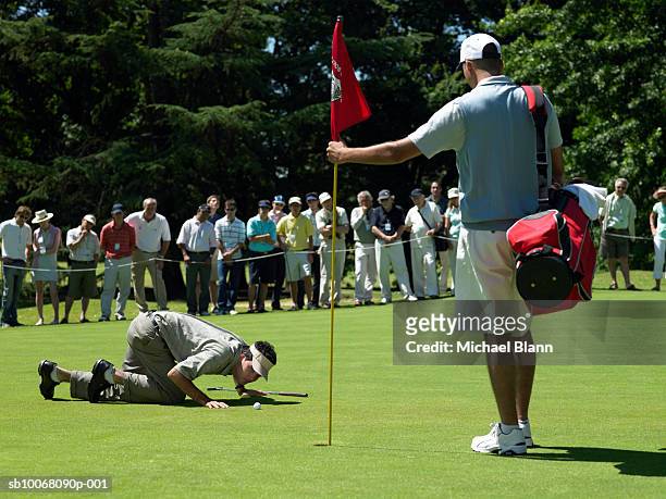 golfer having close look at ball on course - golf championship stock pictures, royalty-free photos & images