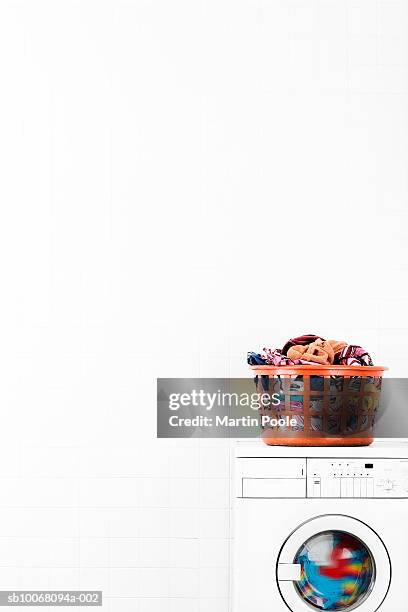 laundry basket on top of washing machine - washing basket stock pictures, royalty-free photos & images