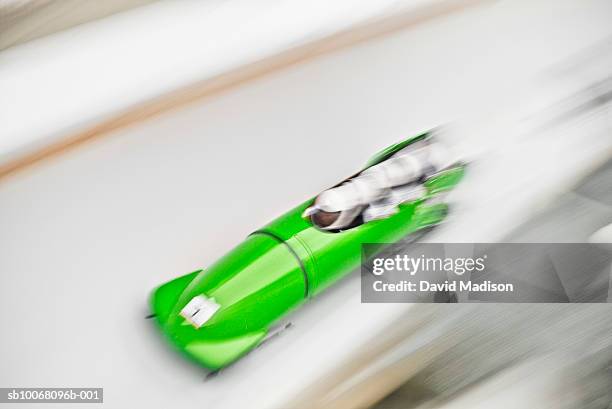 four-man bobsled on track, blurred motion - bob stock-fotos und bilder