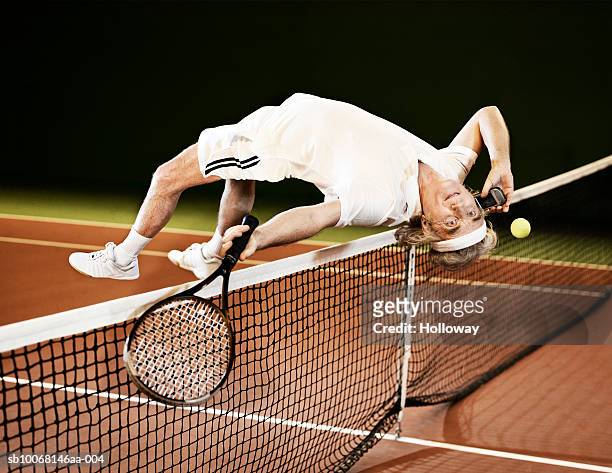 mature man playing tennis and using mobile phone - bizarre bildbanksfoton och bilder