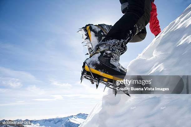 italy, piedmont, alps, man wearing ice climbing crampons, low section, close-up - steigeisen stock-fotos und bilder